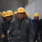 group of persons wearing yellow safety helmet during daytime